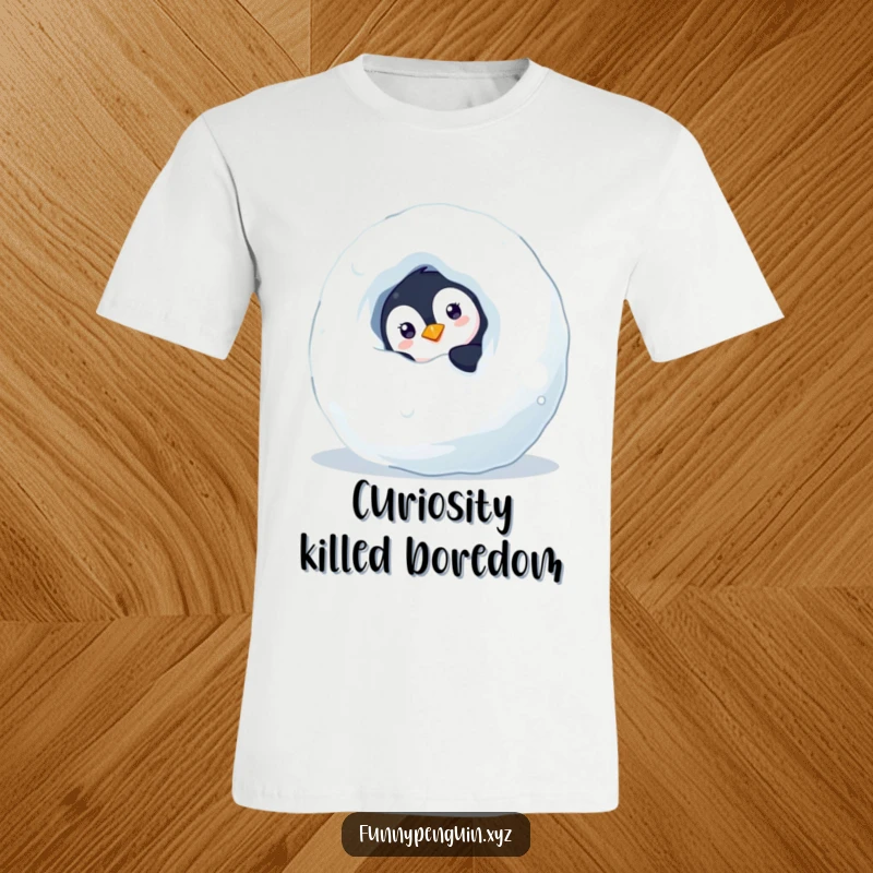 Funny t-shirt showing a curious penguin peeking from behind a snowball, inviting playfulness and winter fun, a great funny gift.